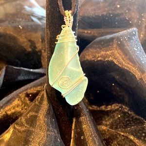 Blue sea glass wire wrapped with silver colored copper wire.